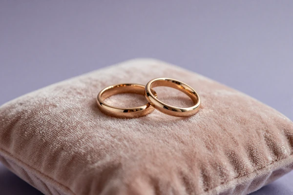 Two rings on blush velvet, illustrating verified cuckold and hotwife couples on the kink dating site
