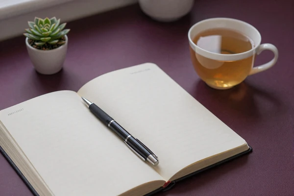 Warm research desk with open notebook and tea cup, illustrating data-driven body-positive dating advice