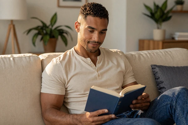 Man reading on a cozy couch, representing the BeyondSize blog with body-positive dating advice